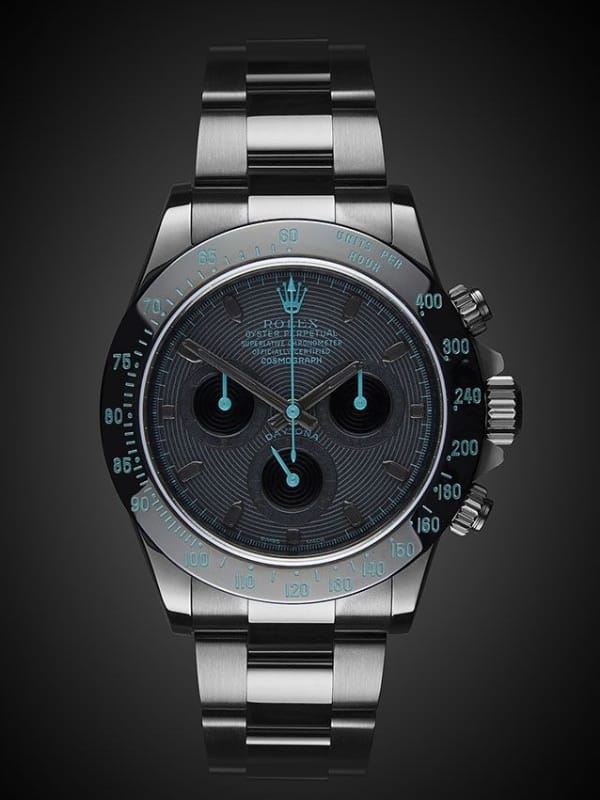 luxury watch for mensA luxury stainless-steel chronograph watch with a black dial, glowing aqua markers, and a polished metal bracelet