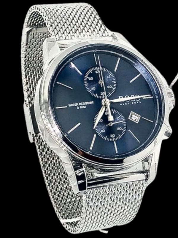 A silver Boss wristwatch with a blue dial, two sub-dials, a date display, and a stainless-steel mesh strap